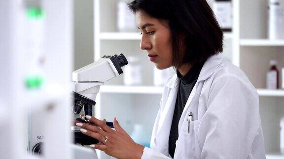 女科学家用显微镜检查样品