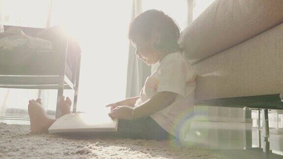 亚洲小男孩在地板上看书