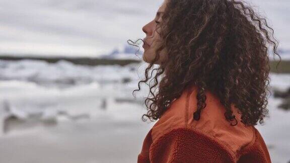 一个留着美丽头发的女人站在冰岛的冰原中间