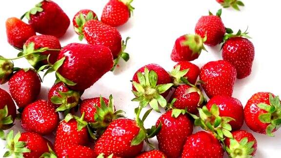 草莓落在白色的背景上缓慢的运动