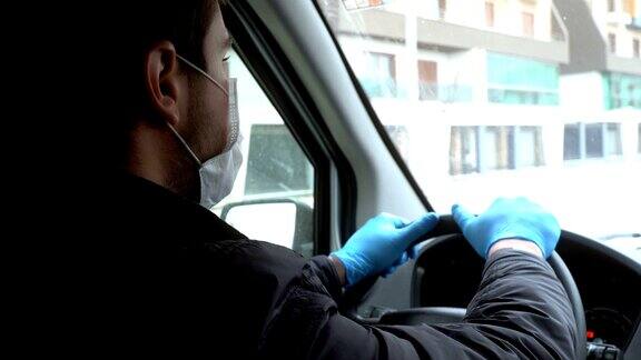 戴着面罩和手套开车的男人预防冠状病毒