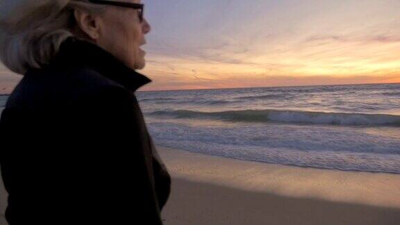 健康退休成熟活跃的女人在海滩上看日落