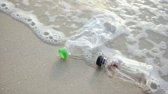 海浪把沙滩上的塑料瓶冲进海里海洋塑料垃圾污染管理问题环境问题拯救世界