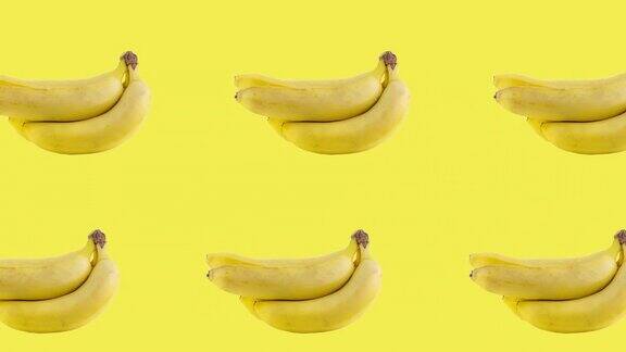 两行许多香蕉动画在不同的方向在一个黄色的背景无缝循环的现实三维热带食物最小动作设计艺术