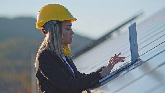 在太阳能发电厂工作的女工程师可再生能源系统太阳能城市