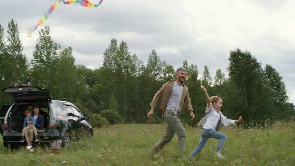 兴奋的小女孩和爸爸在放风筝