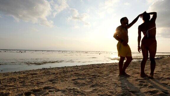 一对夫妇在巴厘岛的海滩上跳舞