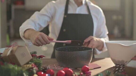 慢镜头亚洲中式甜点厨师厨师准备和搅拌巧克力配料准备脆饼圣诞庆典