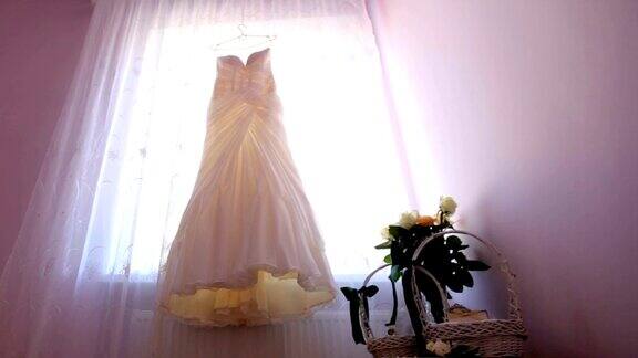 结婚的那一天新娘的礼服挂在窗户上