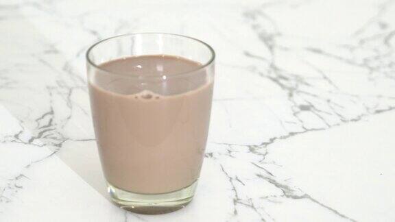 将巧克力牛奶倒入玻璃杯中