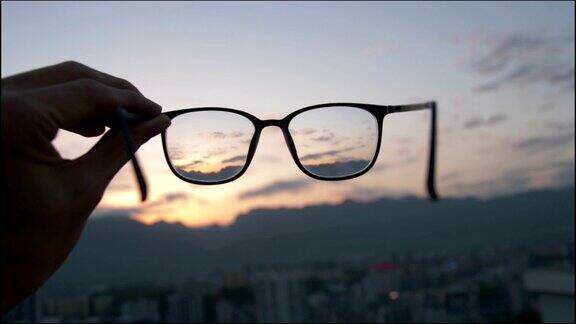 透过眼镜看城市日落