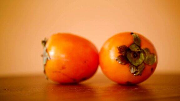 成熟的甜柿子配上橙色的背景