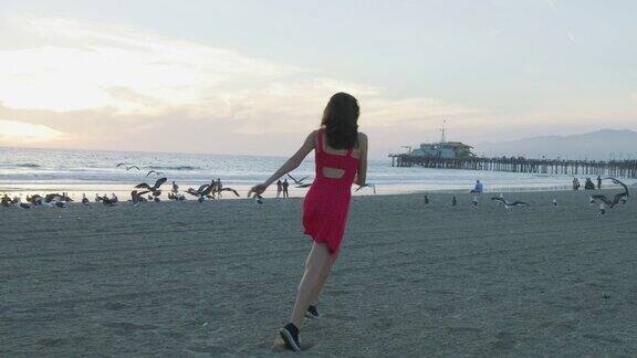 快乐的女孩在沙滩上奔跑