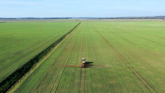 农用拖拉机在绿色农田上喷洒除草剂、农药和化肥