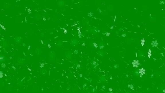 雪花飘落在绿色的背景上