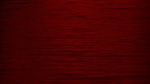 抽象模糊的深红平静的波浪移动背景纹理