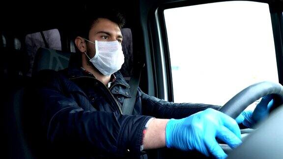 戴着面罩和手套开车的男人预防冠状病毒