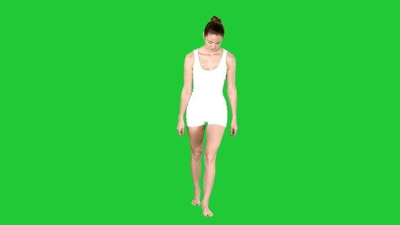 苗条的模特在绿色屏幕上行走白色内衣色度键