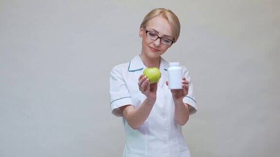 营养学家医生健康生活方式概念-持有机青苹果和一罐维生素丸