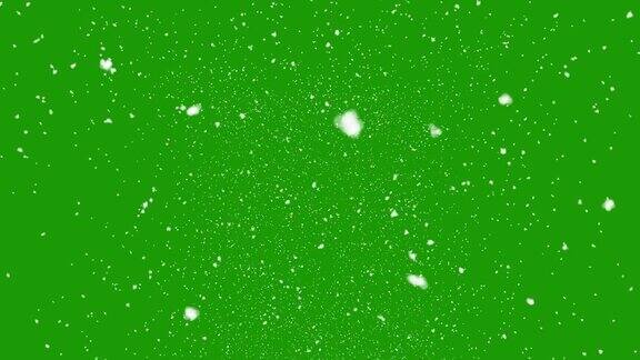 孤立的雪花落在绿色屏幕上