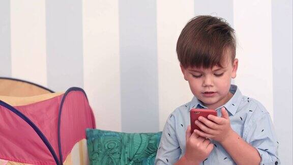 一个兴奋的小男孩正在看手机短信
