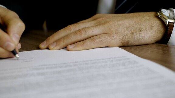商人签商务合同协议男手捂着笔写签名这个人修改并填写了文件