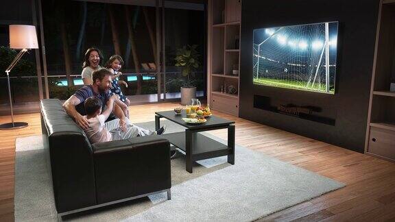 一个家庭正在看电视上的足球时刻庆祝进球
