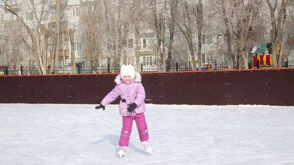 小女孩笑着在冰上溜冰