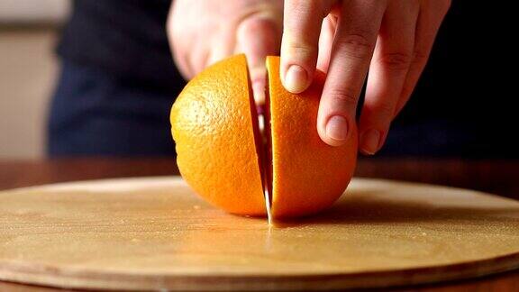 在木板上切橘子的女人特写镜头