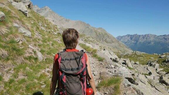 在阿尔卑斯山徒步旅行的女人慢镜头后视镜