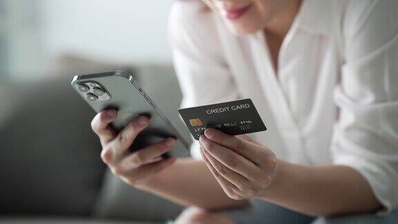 女人在手机上插入信用卡号码慢动作
