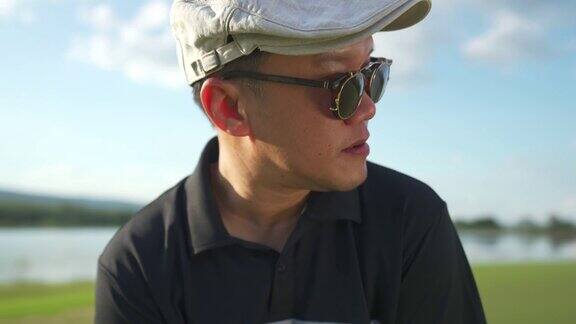 亚洲男子高尔夫球手在夏天阳光灿烂的一天高尔夫球场高尔夫的4K肖像