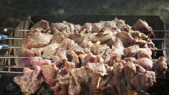 户外烧烤生肉把新鲜的肉串放在木炭烤架上