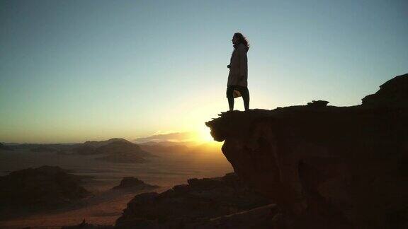 从岩石上看瓦迪拉姆沙漠的女人