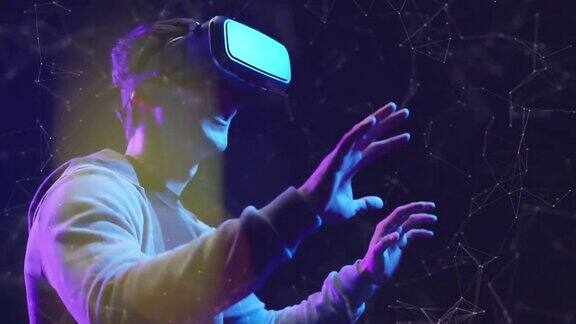 青少年玩VR虚拟现实眼镜运动游戏3D网络空间未来霓虹五彩背景未来数字技术游戏和娱