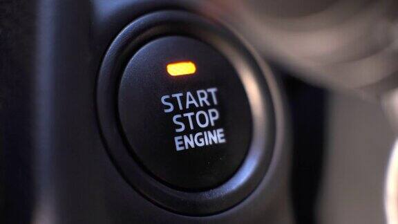 在汽车里人们按下按钮启动引擎
