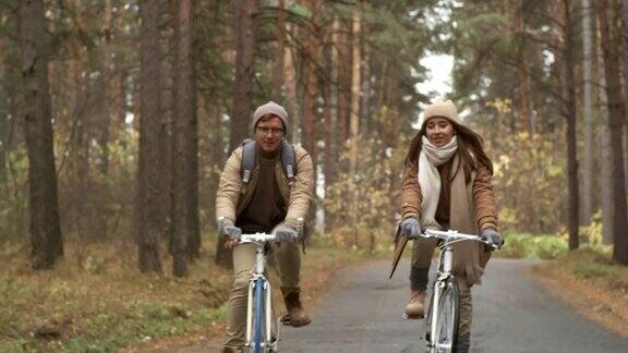 在小雪阵雨中骑自行车的夫妇