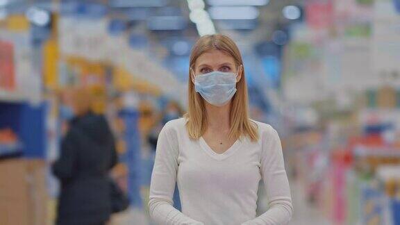 肖像一个年轻美丽的女人在一个医疗面具站在超市隔离期间购买食品、冠状病毒、新冠病毒4kProRes