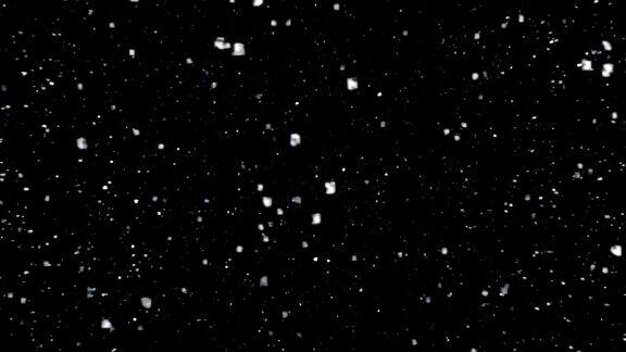 几粒雪花落在黑色的背景上