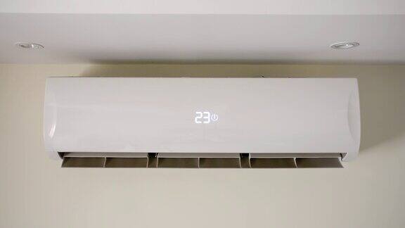 打开空调开关启动房间墙壁上的空调改变温度冷却装置分体系统