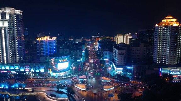夜晚照亮三亚市交通街道十字路口江边航拍全景4k中国海南