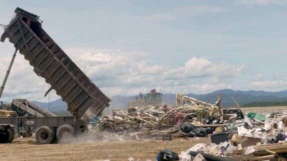 在垃圾填埋场倾倒建筑垃圾的大型自卸卡车