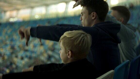 学生球迷和小男孩在体育场观看体育比赛