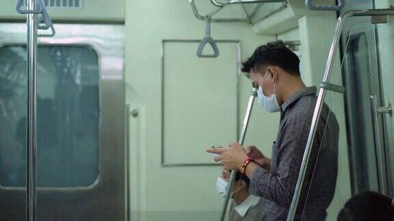 在地铁上用手机旅行的年轻人