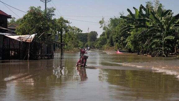 一辆旧摩托车停在被洪水淹没的街道上