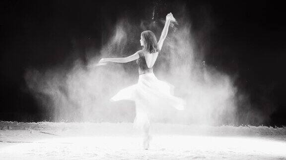 年轻的芭蕾舞者跳进白色的粉末云