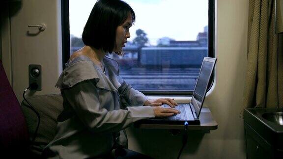 女人在火车上使用笔记本电脑