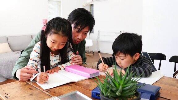 父亲帮助孩子们做作业