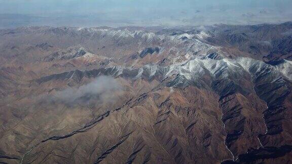 鸟瞰图的棕色山与雪从飞机