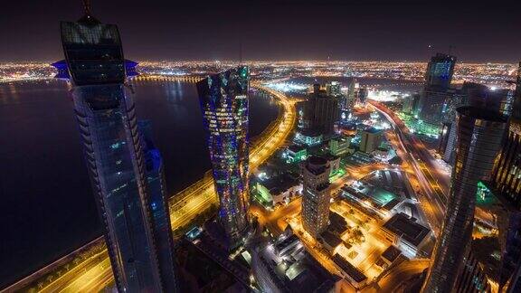 夜晚照亮多哈城市著名的塔屋顶市中心海湾全景4k时间流逝卡塔尔
